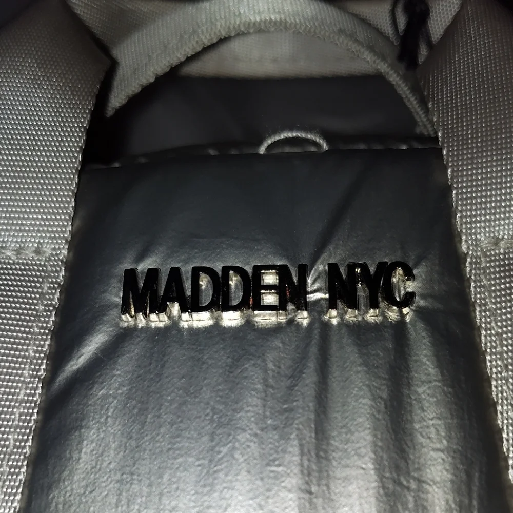 Steve Madden Silver Backpack. Front and side pockets.
